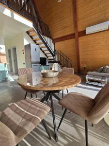 a wooden table and chairs in a living room at V Peaks Family A Frames in Dilijan in Dilijan +29 photos