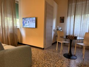 a living room with a couch and a table and chairs at Villa Catelli in Lucca