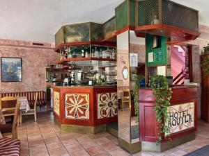 a restaurant with a bar in a room at Hotel Aquila in Livigno