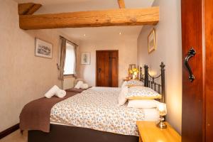 a bedroom with a large bed in a room at Ystumgwern Luxury Barn Conversions in Dyffryn
