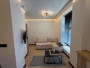 a living room with a couch and a table at Apartament Ania Nysa Centrum z bezpłatnym parkingiem in Nysa