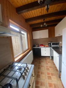 a kitchen with a stove top oven in a room at Pensiunea Ana in Ceahlău