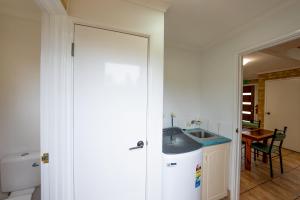 a kitchen with a sink and a counter top at Esperance Foreshore Apartments in Esperance +65 photos