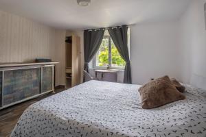 a bedroom with a large bed and a window at Chambre d'hotes 2 à Bramefort in Champsac