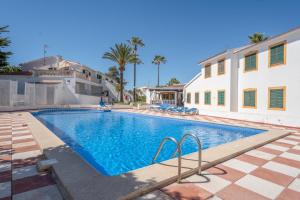 a swimming pool in front of a house at Villa Noa in Cala en Bosc +15 photos