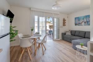 a living room with a table and a couch at Villa Noa in Cala en Bosc