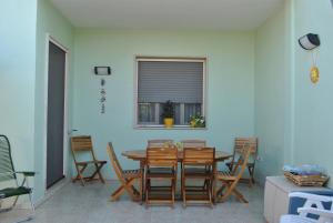 a dining room with a wooden table and chairs at Casa Salina in Torre Colimena