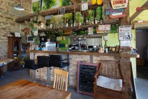 a bar in a restaurant with a table and chairs at Chambre d'hotes 3 et 4 a la ferme in Champsac