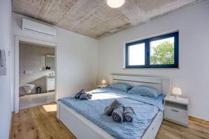 a bedroom with a large bed with blue sheets at Villa Nono in Motovun +26 photos