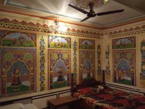 a bedroom with a painting on the wall at Hotel Grand regus in Bangalore