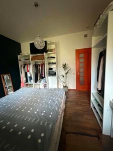 a bedroom with a bed and some open shelves at Butas Karklėje in Karklė