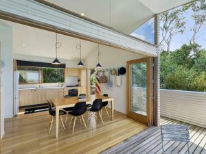a kitchen and dining room with a table and chairs at Wye View in Wye River