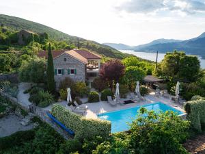 an aerial view of a house with a swimming pool at Villa Stari Mlin in Luštica