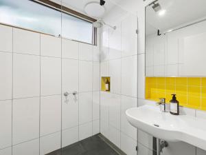 a white bathroom with a sink and a shower at Wye View in Wye River +26 photos