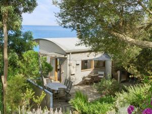 a house with a deck and the ocean in the background at Wye View in Wye River
