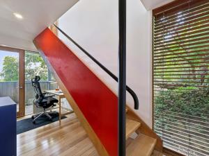 an office with a red staircase in a house at Wye View in Wye River