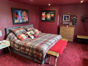 a bedroom with a bed and a wooden dresser at The Flat The Plough in Birdbrook +1 photo