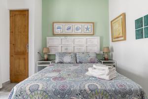 a bedroom with a bed and two night stands at Girasol in Vejer de la Frontera