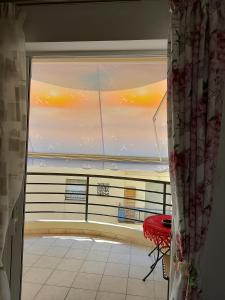 a room with a window with a view of the ocean at Alkyona in Patra