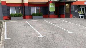 an empty parking lot in front of a building at Mia Hotel in Rivne +10 photos