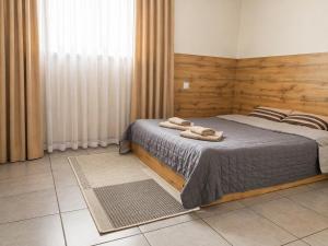 a bedroom with a bed with two towels on it at Mia Hotel in Rivne