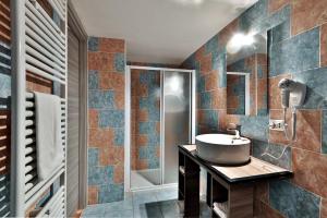 a bathroom with a sink and a shower at Ca' Rossa in Roe