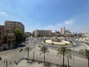a city with a street with palm trees and a fountain at Grand lotus hotel downtown in Cairo +16 photos