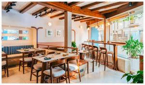 a restaurant with wooden tables and bar stools at Fortune 603 in Mumbai