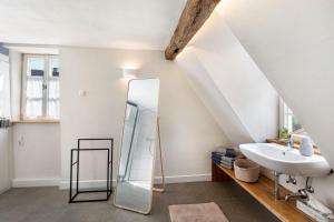 a bathroom with a mirror and a sink at Ferienhaus Gerbertor am Goldbach in Dörzbach +33 photos