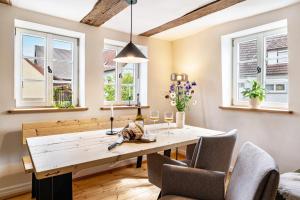 a dining room with a wooden table and chairs at Ferienhaus Gerbertor am Goldbach in Dörzbach