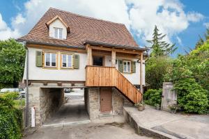 a house with a balcony on the side of it at Ferienhaus Gerbertor am Goldbach in Dörzbach