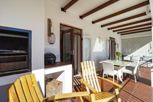 a kitchen and dining room with a table and chairs at Winelands Golf Lodges 24 in Stellenbosch