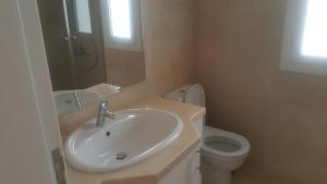 a bathroom with a sink and a toilet at Twin Lagoon Apartment at White Villas El Gouna in Hurghada