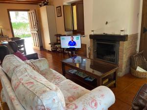 a living room with a couch and a fireplace at VILLA ISABEL in Piloña