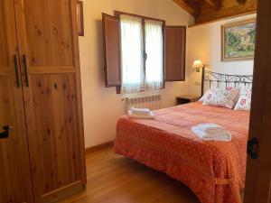 a bedroom with a bed with two towels on it at VILLA ISABEL in Piloña