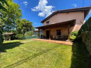 a house with a patio and a yard at VILLA ISABEL in Piloña