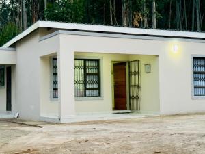 a small white house with a door at Goshen villas in Mbabane