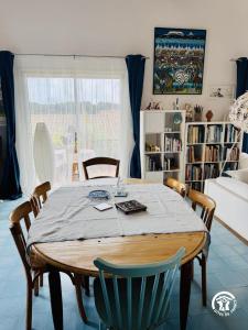 a dining room table with chairs in a living room at Entre mer et village in Leucate +9 photos