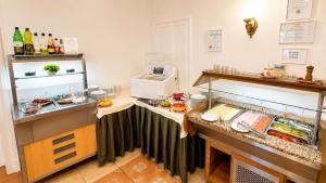 a kitchen with a counter with food on it at Batthyány Kastélyszálló in Zalacsány +145 photos