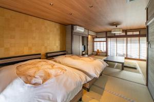 a bedroom with a large dog sleeping on a bed at 湯宿ささくら in Kinosaki