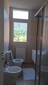 a bathroom with a toilet and a window at Risorgimento 8 appartamento centro Santa Maria Maggiore Valle Vigezzo in Santa Maria Maggiore +18 photos
