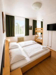 a large white bed in a room with a window at Hotel Kaffeemühle in Vienna