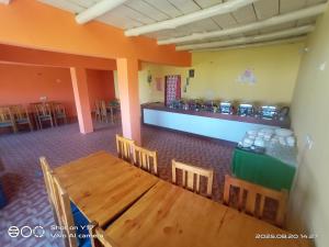 a dining room with a table and chairs and a counter at Kayok camp hunder in Nubra