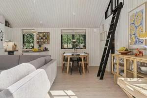 a living room with a couch and a table at Nordic Nature Hideaway in Yderby