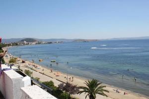 a beach with a bunch of people in the water at Grand Erdek Hotel in Erdek