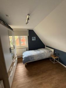 a small bedroom with a bed in a attic at Ferienhaus SPO 54 grad in Böhl