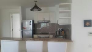 a kitchen with white cabinets and a counter top at Twin Lagoon Apartment at White Villas El Gouna in Hurghada +30 photos