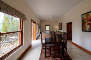 a dining room with a table and chairs and a window at IL Castello Boutique Hotel in Clarens