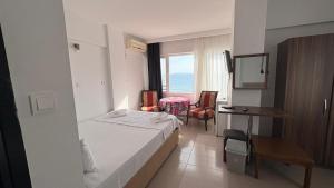 a hotel room with a bed and a desk and a window at Grand Erdek Hotel in Erdek +18 photos