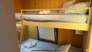 two bunk beds in a room with a window at HappyPlace - Kolpa PremiumMobileHome in Metlika